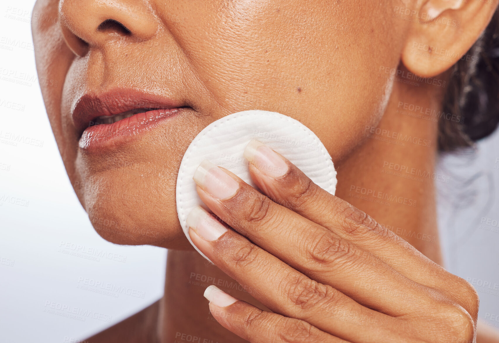 Buy stock photo Beauty, closeup or woman with cotton pad for dermatology, wellness or facial skincare routine in studio. White background, hand or face of lady cleaning with swab for glow, cleansing or dirt removal