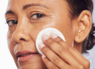 Buy stock photo Face, portrait or senior woman with cotton pad for dermatology, wellness or healthy facial skin. Studio background, skincare or mature person cleaning with swab for beauty, cleansing or dirt removal