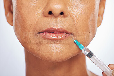 Buy stock photo Lips, injection and face of woman for plastic surgery in studio, white background and skincare. Closeup of female model, cosmetics and syringe on mouth for dermatology, facelift and filler for beauty