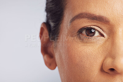 Beauty, eye closeup and woman in studio with vision for cosmetics and mature skincare. Isolated, gray background and makeup with microblading portrait with dermatology and natural glow of model