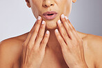 Wow, pouting or hands of a woman for skincare, beauty or dermatology wellness. Surprise, anti aging and face or manicure of a model for cosmetic nails or glow isolated on a studio background