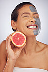 Woman, skincare, with grapefruit and face mask with charcoal, clay or natural beauty product for wellness, detox or nutrition. Fruit, healthy cosmetics and girl happy with vitamin c or facial care 