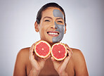 Woman with grapefruit, skincare and face mask with charcoal, clay or natural beauty product with vitamin c, wellness or detox. Fruit, healthy cosmetics and girl happy with dermatology or facial care 