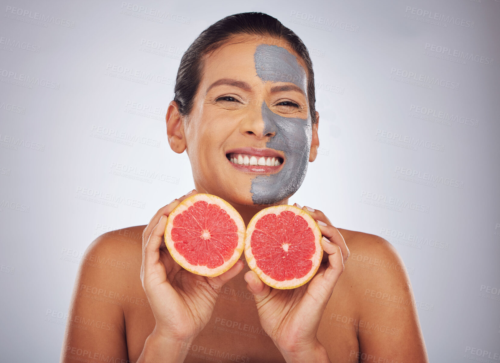 Buy stock photo Woman with grapefruit, skincare and face mask with charcoal, clay or natural beauty product with vitamin c, wellness or detox. Fruit, healthy cosmetics and girl happy with dermatology or facial care 