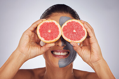 Buy stock photo Hands with grapefruit, skincare and face mask with clay, charcoal or natural beauty product for wellness, detox or nutrition. Fruit, woman in funny pose and healthy cosmetics for facial care 