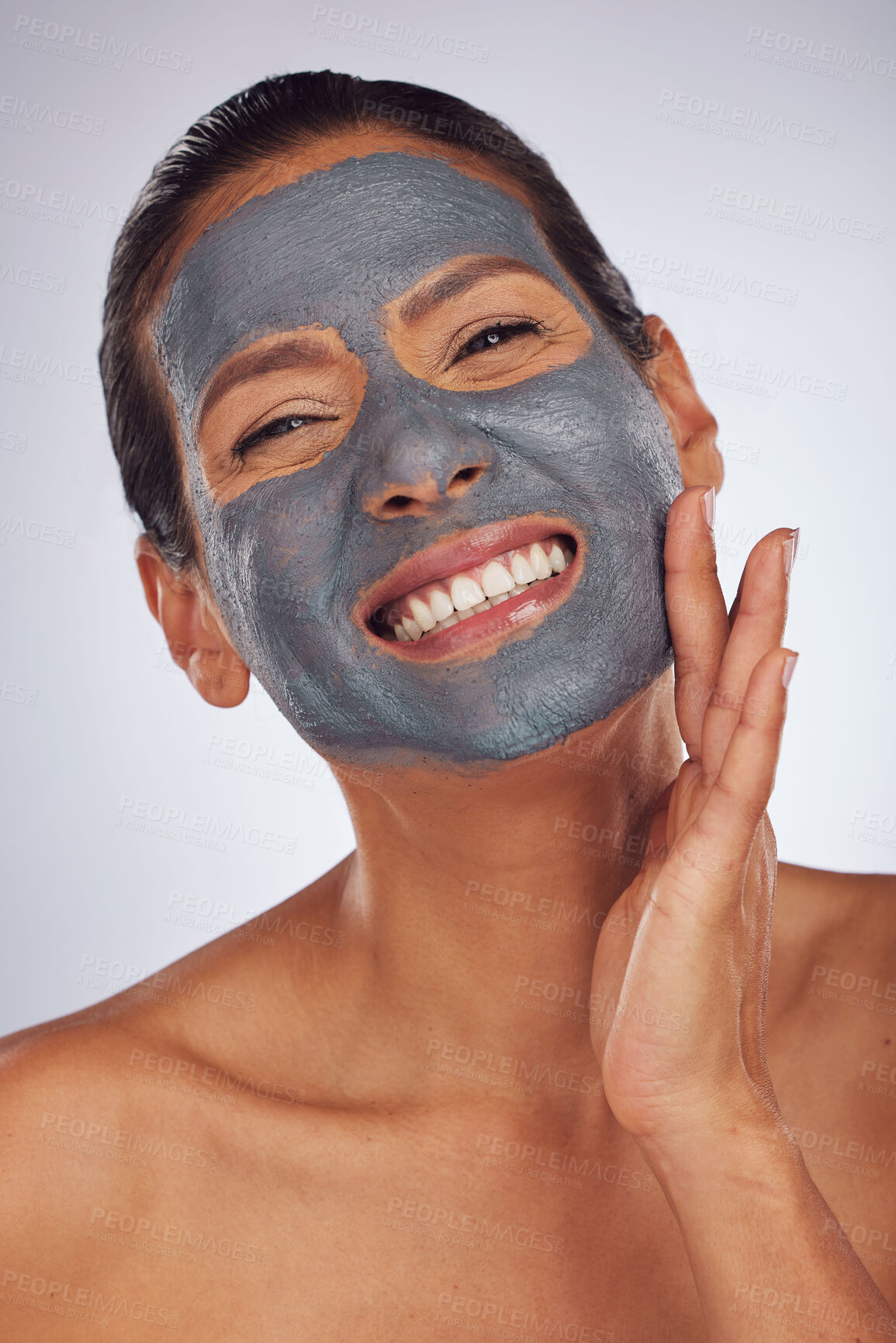 Buy stock photo Happy woman, charcoal mask and portrait for beauty, aesthetic dermatology and self care on studio background. Mature female model touch face with clay skincare product, facial cosmetics and smile 