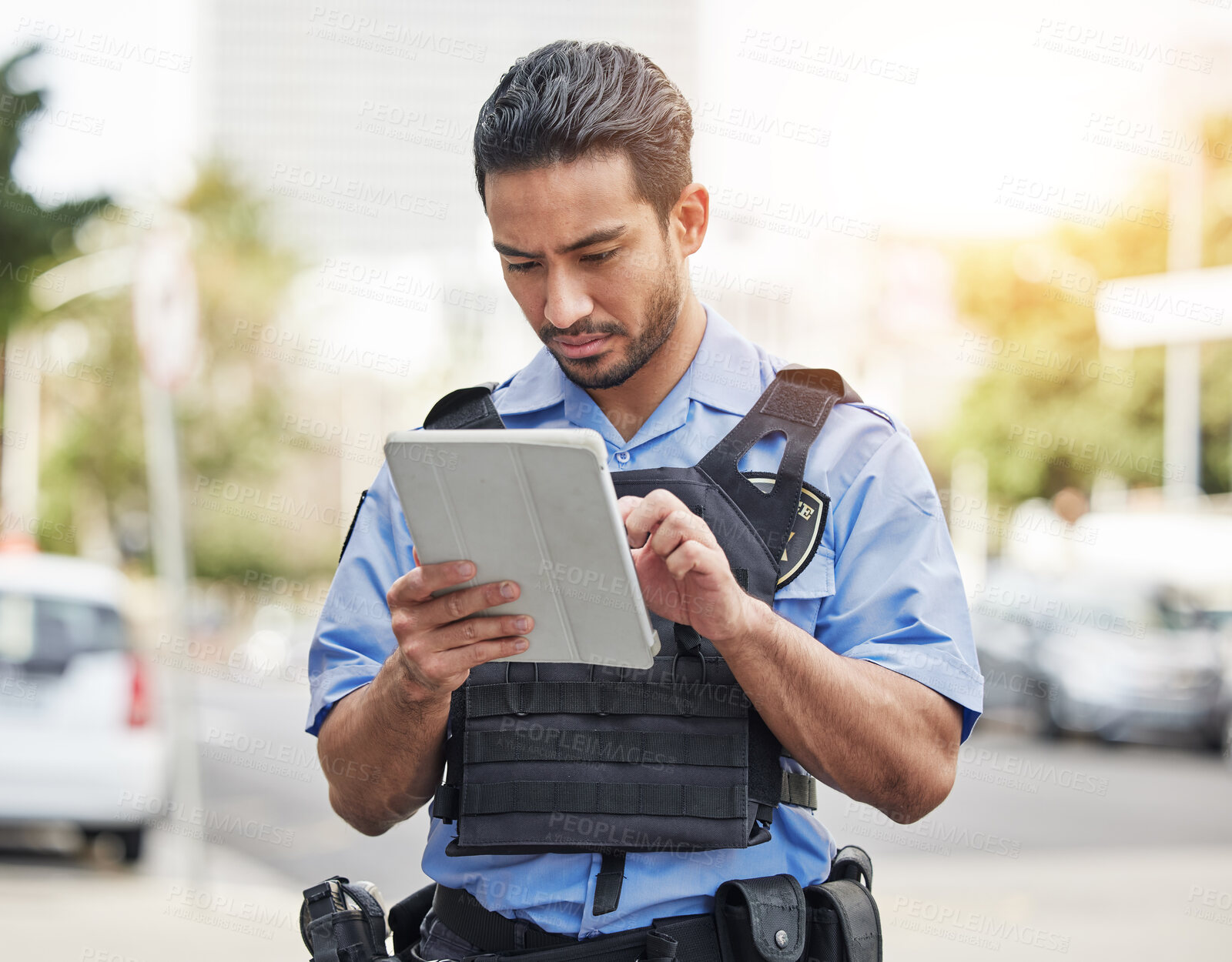 Buy stock photo Police, tablet and patrol with a man officer outdoor on the street, using the internet to search during an investigation. Technology, information or law enforcement with a male security guard on duty