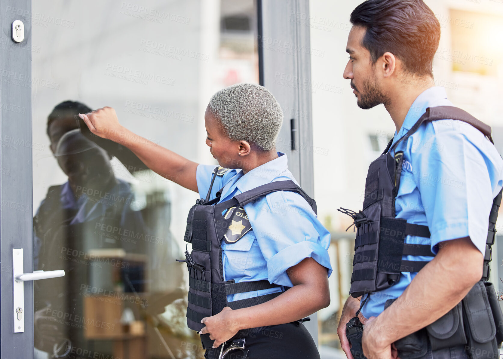 Buy stock photo Crime, patrol and police knocking on a door for justice, security and law at a home. Together, teamwork and a black woman and man at a house for service, check and helping the community for work