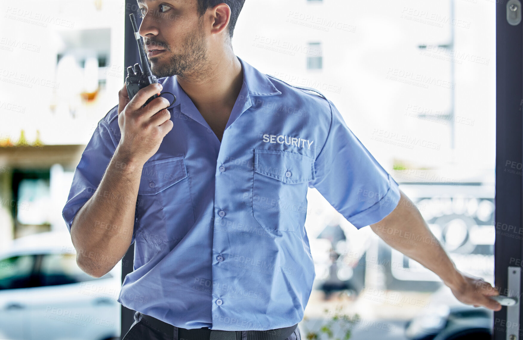 Buy stock photo Man, radio and watch at job as security guard in city, walkie-talkie and contact for backup, support or safety in building. Protection agent, tech and report information at door in crime surveillance