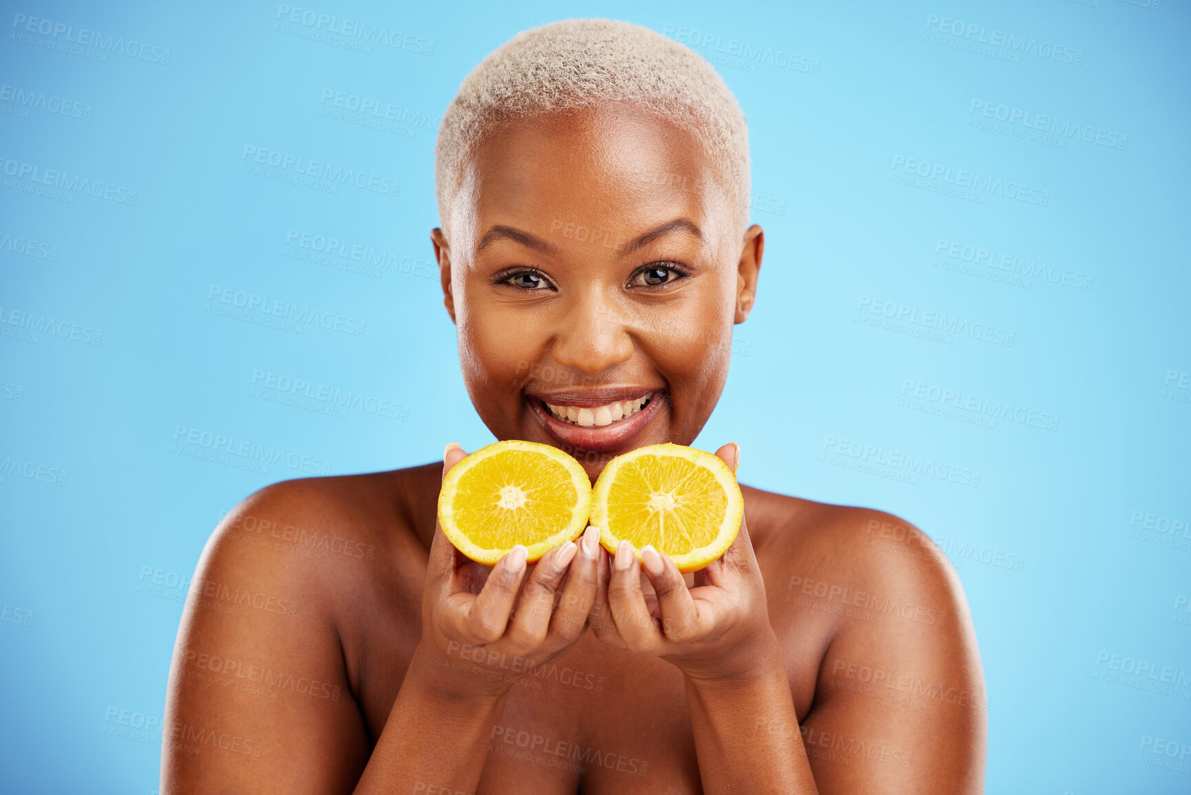 Buy stock photo Portrait, skincare and fruit or nutrition with a black woman in studio on a blue background for health. Smile, beauty and orange with a happy young female person holding food for natural wellness