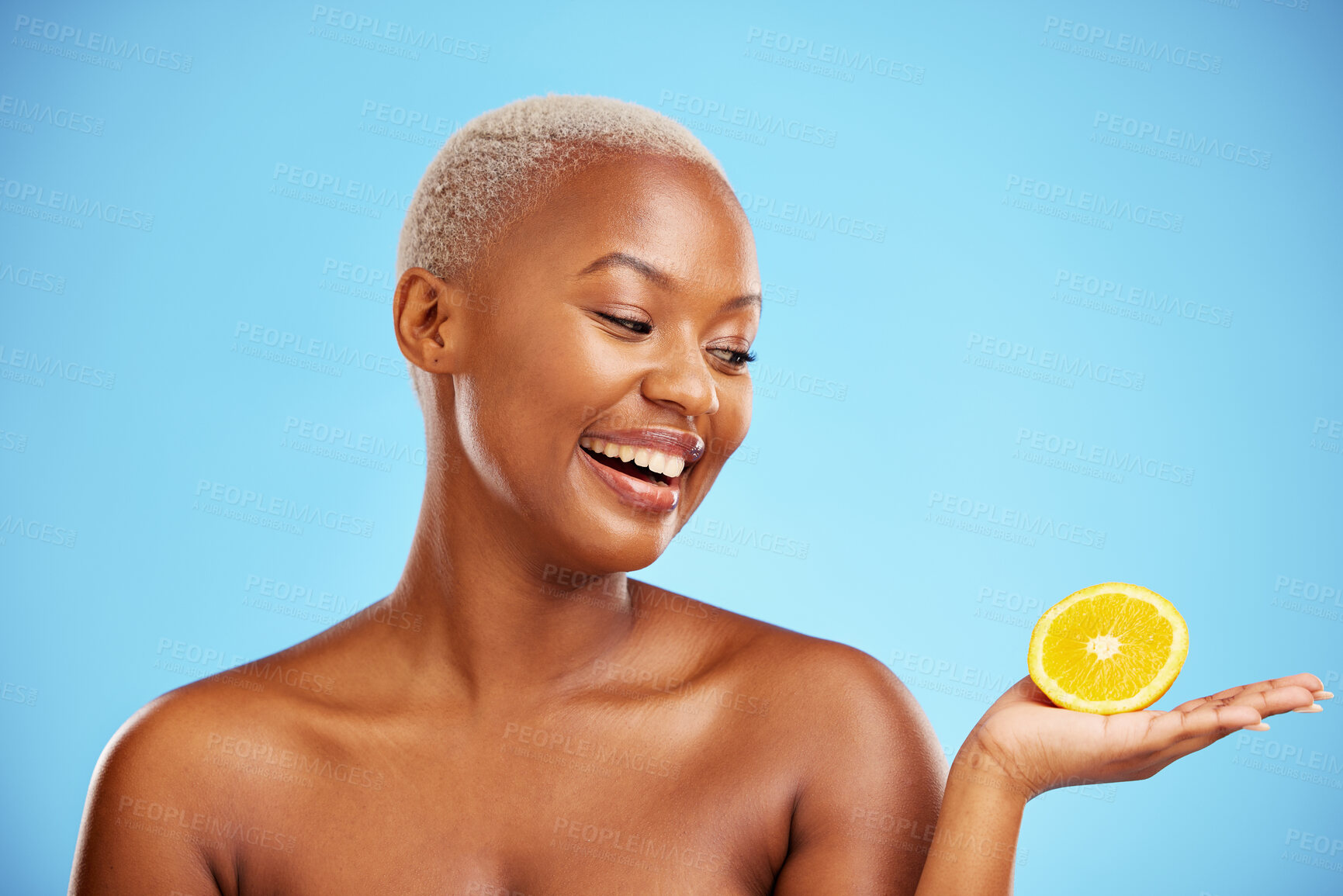 Buy stock photo Orange, beauty or health and a model black woman in studio on blue background with fruit in the palm of her hand. Natural, skincare or diet with a happy young person holding healthy food for wellness