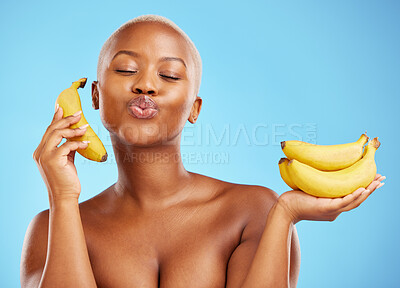 Buy stock photo Black woman, banana and diet for potassium, vitamin or fiber against a blue studio background. Face of calm African female person with bunch of yellow fruit for health and wellness on mockup space