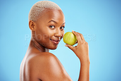 Buy stock photo Happy black woman, portrait and apple for nutrition or healthy diet against a blue studio background. African female person smile with natural organic green fruit for food snack, health and wellness