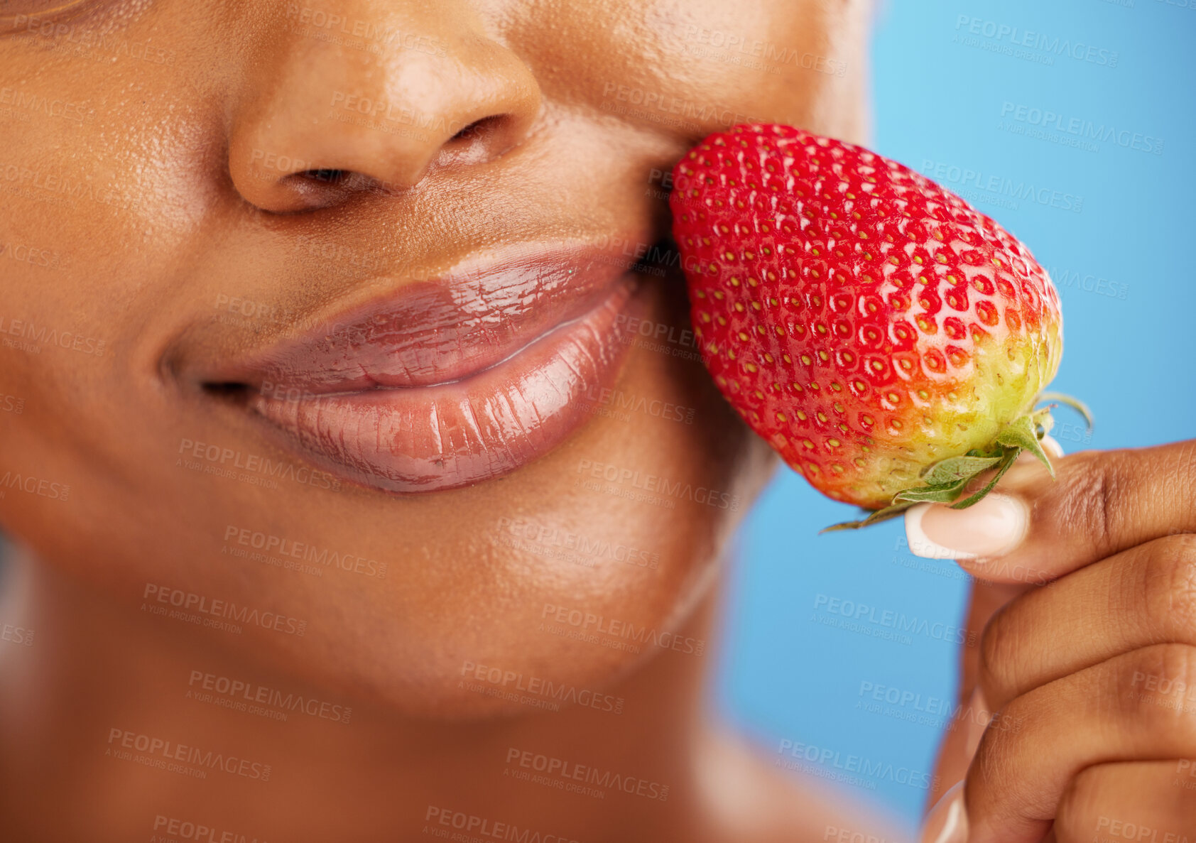 Buy stock photo Strawberry, lips and beauty woman for cosmetics, eco friendly product and color choice. Happy, mouth and skincare person or model, red fruit and dermatology or vegan makeup on studio blue background