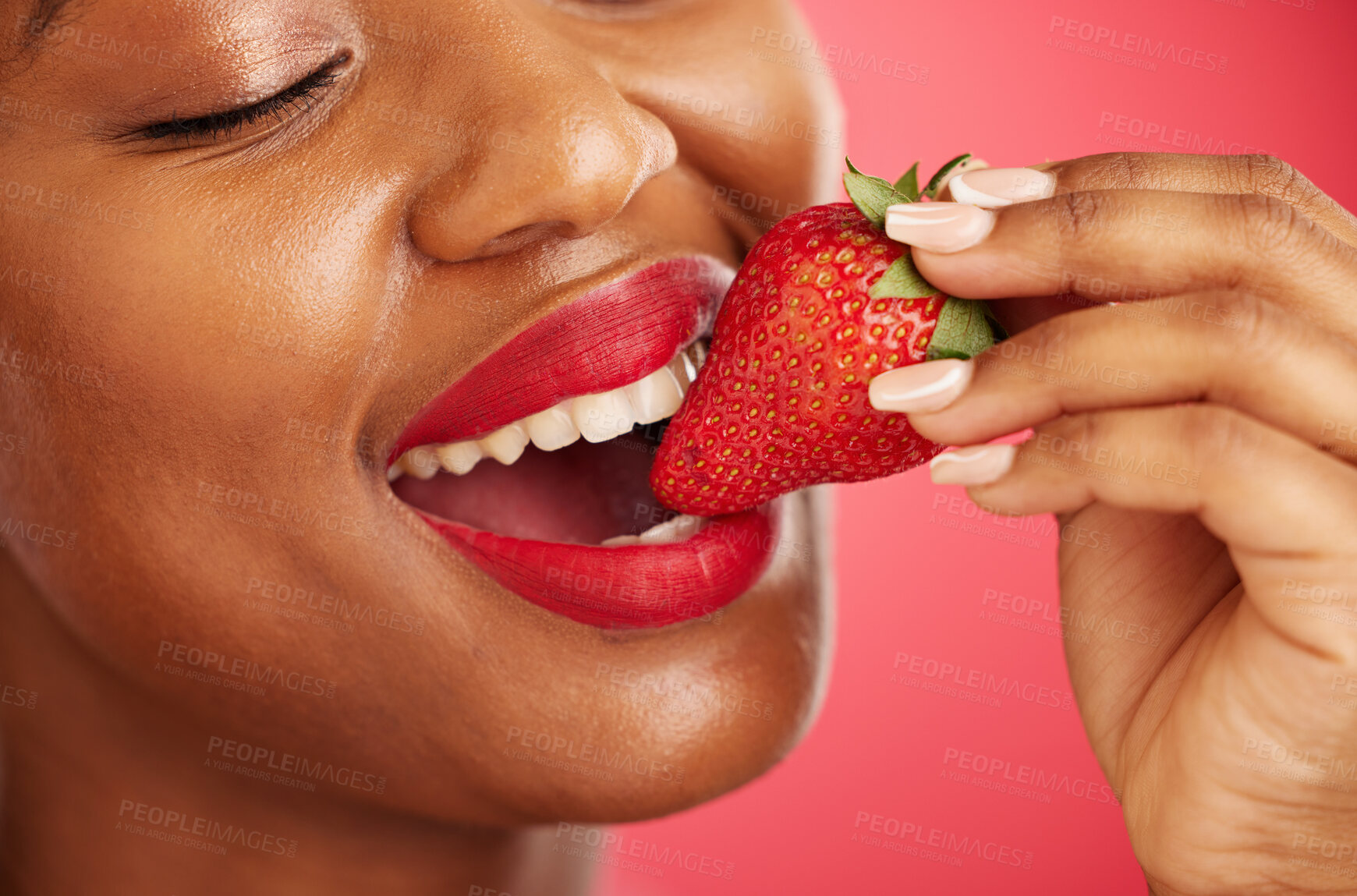 Buy stock photo Strawberry, lipstick and woman lips eating, eco friendly product and color choice or dermatology. Happy mouth of african person or model with skincare, fruit and vegan makeup on studio red background