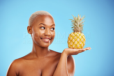 Buy stock photo Black woman, pineapple and palm for diet, natural nutrition or health against a blue studio background. African female person smile in happiness holding organic fruit for vitamin, fiber or wellness