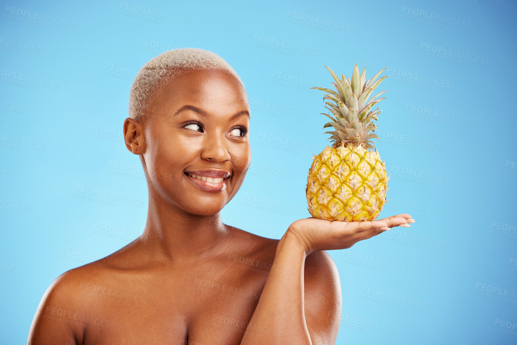 Buy stock photo Black woman, pineapple and palm for diet, natural nutrition or health against a blue studio background. African female person smile in happiness holding organic fruit for vitamin, fiber or wellness