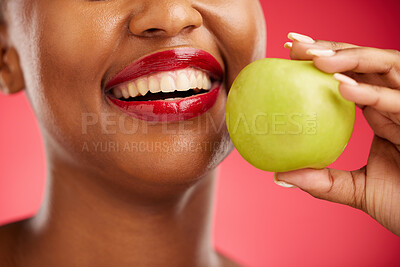 Buy stock photo Woman, mouth and apple in diet, nutrition or health and wellness against a red studio background. Closeup of female person smile with lipstick or natural organic fruit in vitamin, fiber or food snack