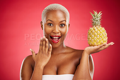 Buy stock photo Beauty, portrait and pineapple surprise with a woman in studio for healthy food, diet or fruit. Black person with makeup on red background for face wellness, natural cosmetics and wow skin care glow