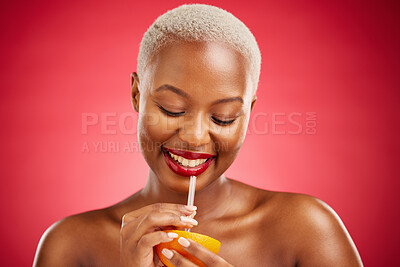 Buy stock photo Happy black woman, orange and vitamin C for diet or natural nutrition against a red studio background. African female person smile and drinking organic citrus fruit with straw on mockup space