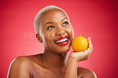 Buy stock photo Orange, thinking and black woman with skincare, cosmetics and vitamin c on a red studio background. Female person, ideas and model with citrus fruit, makeup and wellness with natural beauty and detox