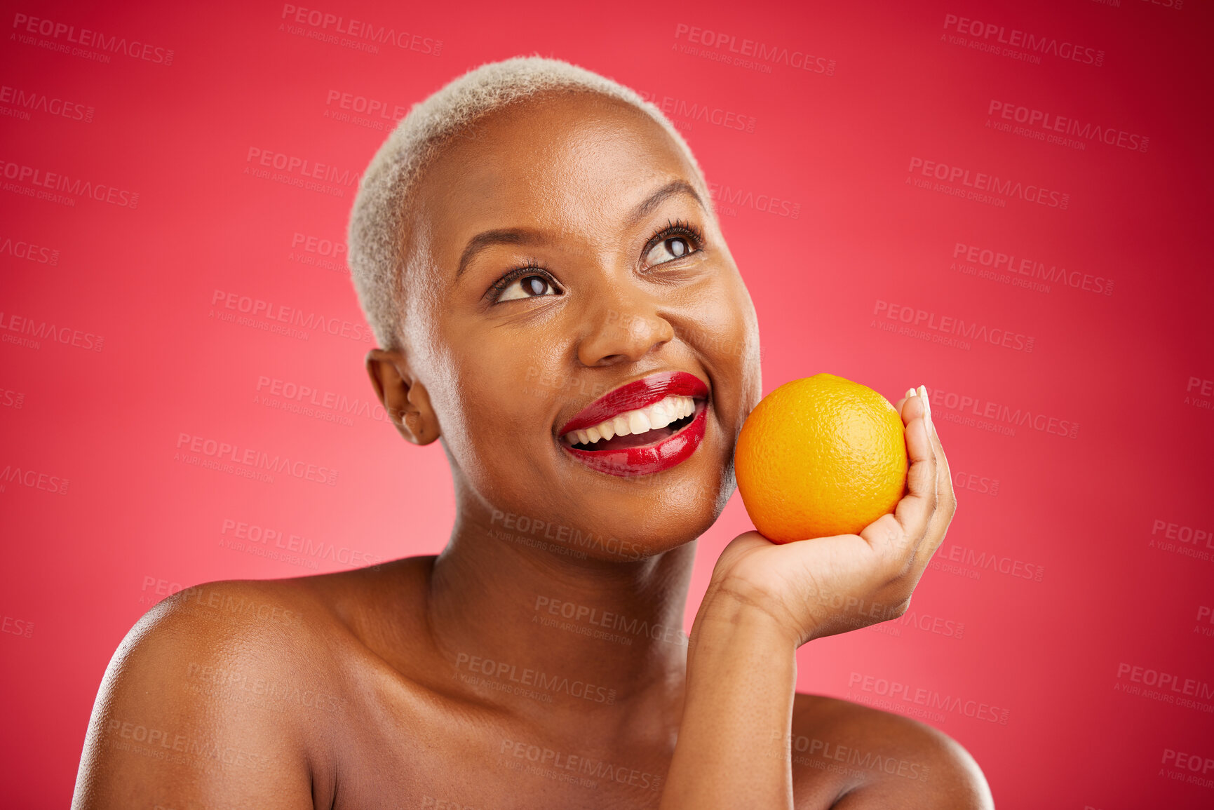 Buy stock photo Orange, thinking and black woman with skincare, cosmetics and vitamin c on a red studio background. Female person, ideas and model with citrus fruit, makeup and wellness with natural beauty and detox