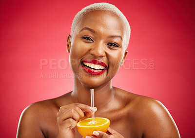 Buy stock photo Happy black woman, portrait and orange for vitamin C, diet or natural nutrition against a red studio background. African female person smile and drinking organic citrus fruit with straw on mockup