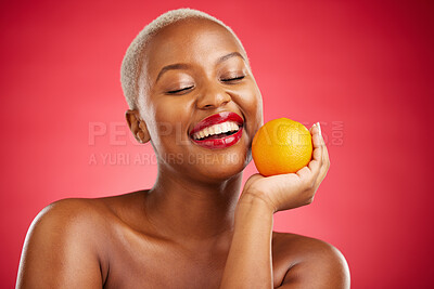 Buy stock photo Orange, smile and black woman with natural beauty, dermatology and vitamin c on a red studio background. Female person, happy or model with citrus fruit, health or wellness with cosmetics or skincare