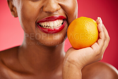 Buy stock photo Woman, mouth and orange for vitamin C, diet or health and wellness against a red studio background. Closeup of female person smile with lipstick and organic citrus fruit for snack, fiber or food