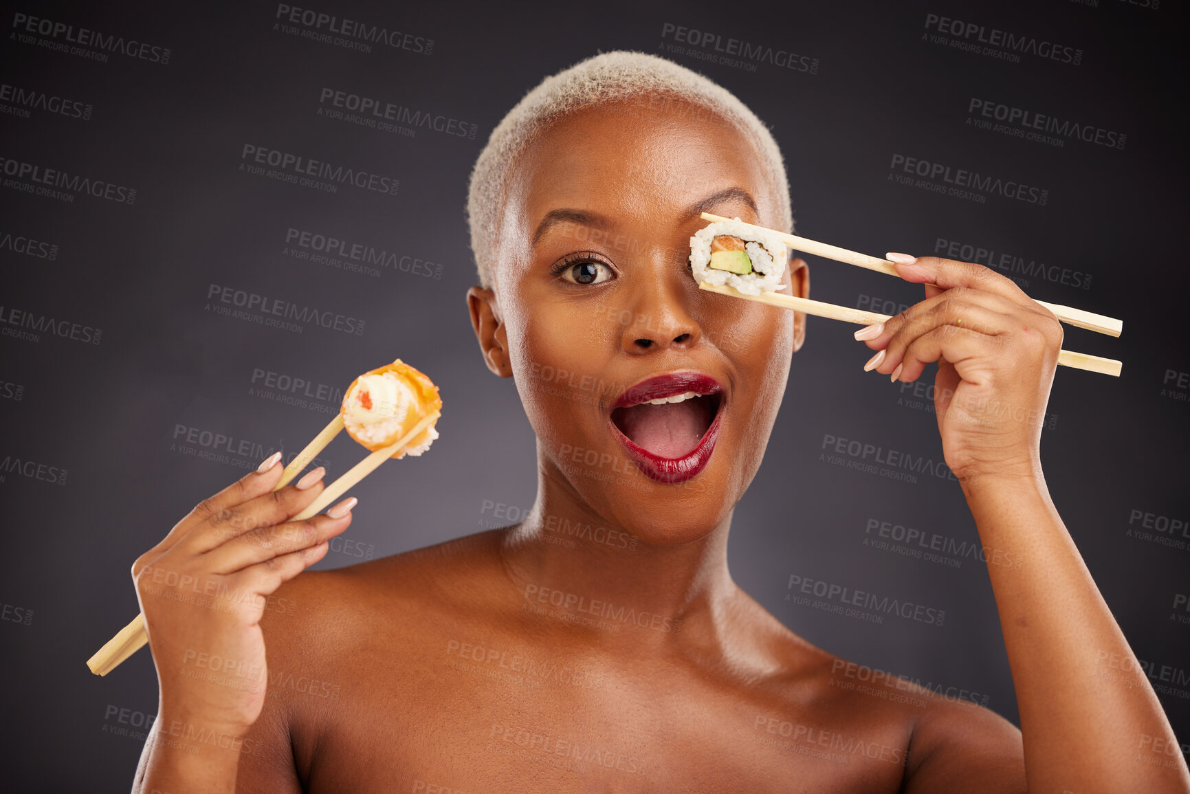 Buy stock photo Sushi, portrait and woman with chopsticks in studio for healthy eating, beauty and food. Face of excited black person with makeup on a dark background for wellness, diet or wow seafood advertising