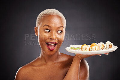 Buy stock photo Face, surprise and woman with sushi plate in studio for healthy eating, beauty or food. Excited black female model with makeup on dark background for wellness glow, wow diet or seafood advertising
