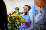 Hospital, sick patient and visitor with flowers at bed with a woman in recovery with support. Healthcare, medical insurance and person with bouquet, family and care with get well soon balloons  