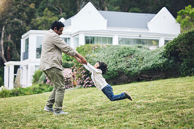Buy stock photo Family, children and a father spinning his son around in the garden of their home while playing together. Kids, yard and bonding with a happy boy child having fun with his dad on grass outdoor
