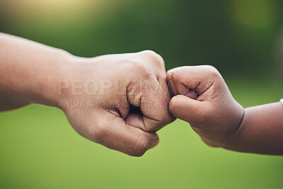 Buy stock photo Fist bump, hands of baby and father with support together or gesture of success or trust in family on blurred background. Hand, bumping fists and dad with son or sign of solidarity or celebration