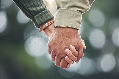 Buy stock photo Love, holding hands and couple together in partnership, marriage or people with trust, bonding or moment in nature with bokeh background. Hand, support and unity with a soulmate or romantic partner