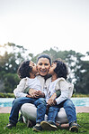 Park, kiss and portrait of mother and children for bonding, quality time and affection outdoors together. Happy family, relax and kids with mom in nature embrace for care, loving relationship and joy