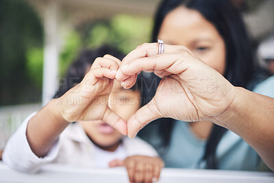 Buy stock photo Mother, child and heart hands for love, care or compassion together in the outdoors. Mom and little kid putting hand for loving emoji, like or sign gesture for support, trust or parenting outside