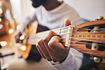 Closeup, hands of man and guitar for music, live talent and creative skill of sound production in home studio. Musician, singer or artist playing notes on acoustic instrument in solo jazz performance