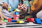 Hands, building blocks and color, learning and development with people at home playing games with toys. Relax on living room floor, parents and children with education activity, family and bonding 
