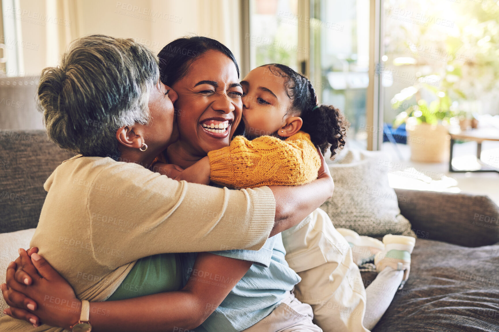 Buy stock photo Grandma, mother and hug child, kiss in home and bonding together, funny and laughing. Happy, mom and embrace kid, grandmother and smile with care, love and enjoying quality time on sofa with family.