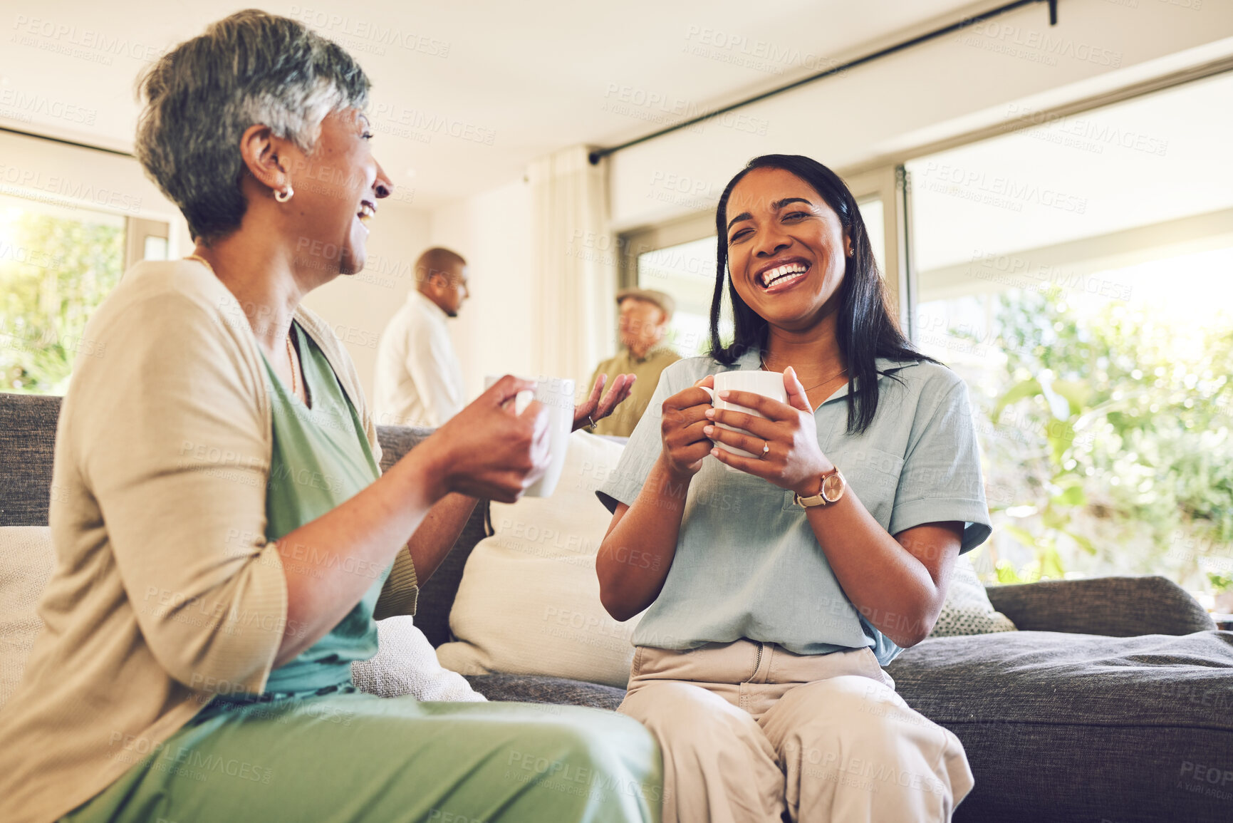 Buy stock photo Woman drinking a cup of coffee with her senior mother while laughing, talking and bonding at home. Happy, smile and elderly female person enjoying a cappuccino with her adult daughter in living room.