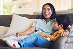 Funny, mother and boy on a couch, love and quality time with happiness, hug and cheerful. Female parent, mom and mama with male child, kid on a sofa and family in a home, wellness and loving together