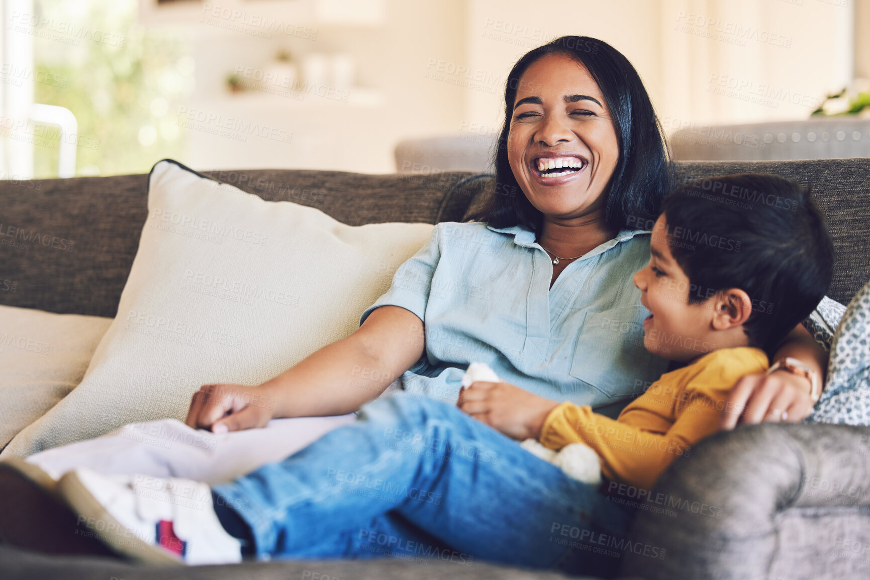 Buy stock photo Funny, mother and boy on a couch, love and quality time with happiness, hug and cheerful. Female parent, happy mom and mama with male child, kid on a sofa and family in a home, laughing and relax