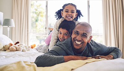 Buy stock photo Bed, playful and portrait of a father with children for love, care or bonding in the morning. Happy, family and a young dad with kids in the bedroom of a house for quality time and playing together