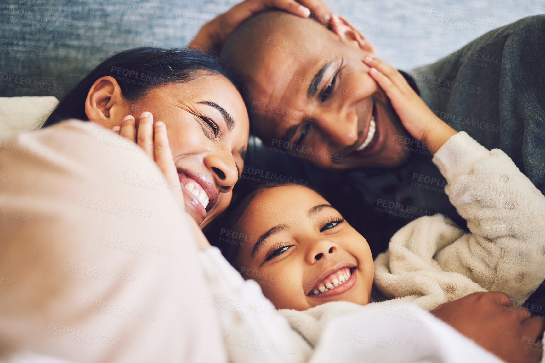 Buy stock photo Home, family and parents relax, quality time and happiness with bonding, peace and loving together. Mother, father and female child with a smile, calm and weekend break with care and kid with support