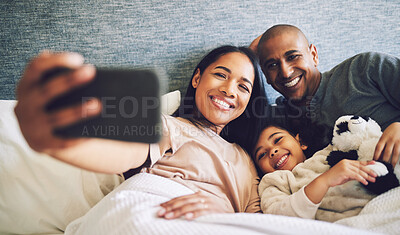 Buy stock photo Family selfie, parents and child in a bed together with love, care and security or comfort. Woman, man and kid relax with a happy smile for quality time, memory or profile picture in a home bedroom