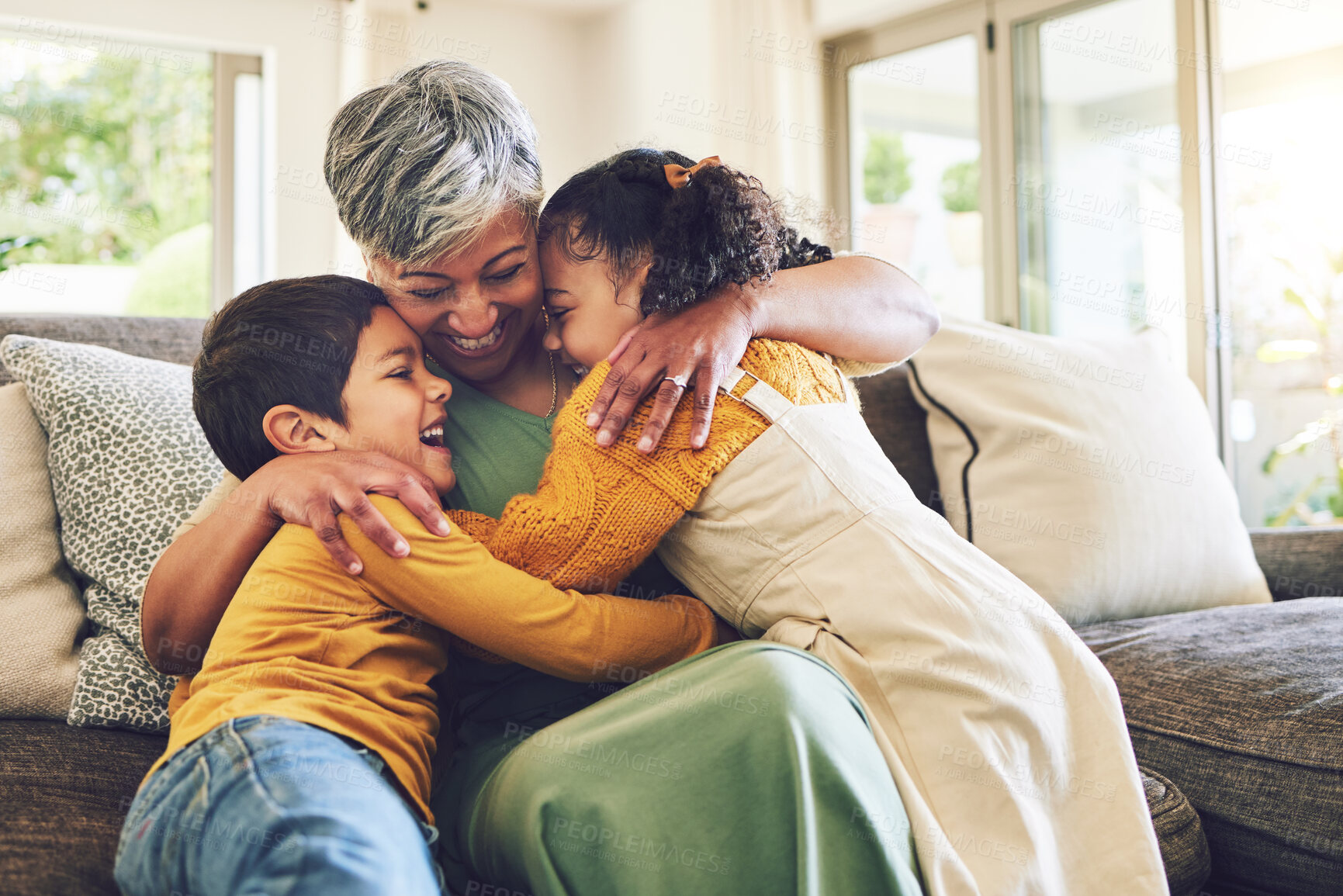 Buy stock photo Hug, grandma or happy kids on a sofa with love enjoying quality bonding time together in family home. Smile, affection or senior grandmother relaxing with young children siblings on house couch 