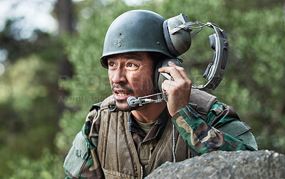 Buy stock photo Army, battle and a man with a headset for communication in a field, help or call for danger. Veteran, hero and a person in the military with gear for support, talking or advice in nature for safety