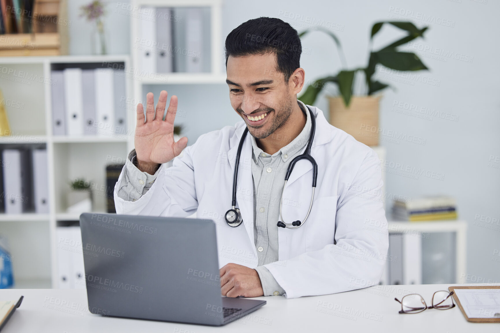 Buy stock photo Video call, doctor and man wave in online meeting, virtual support or clinic and healthcare service on computer. Happy medical worker or asian person on laptop, telehealth help and advice in office