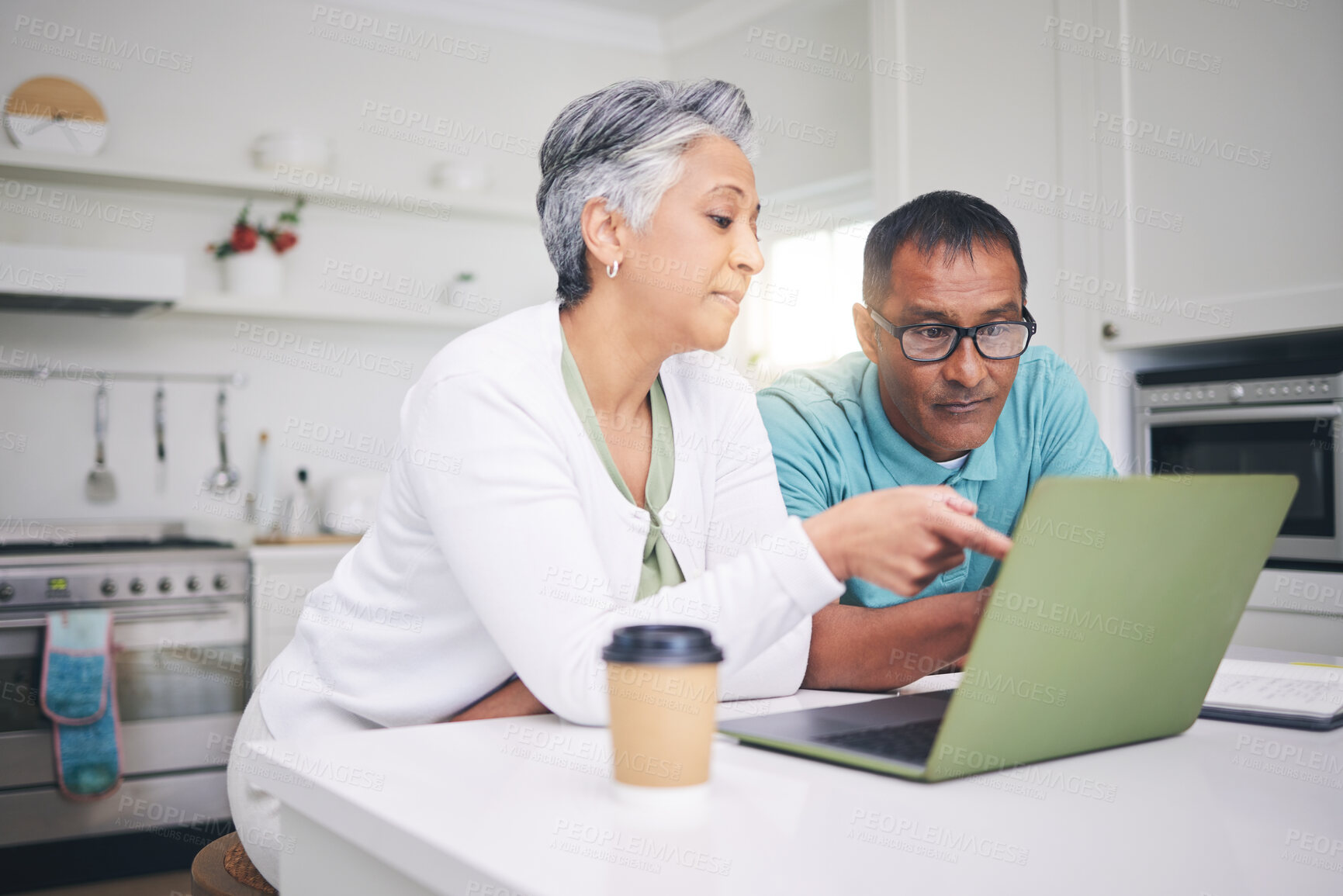 Buy stock photo Mature couple, laptop and pointing for internet connection, communication or social media post. A man and woman talking at home while together for online streaming, search or email with technology